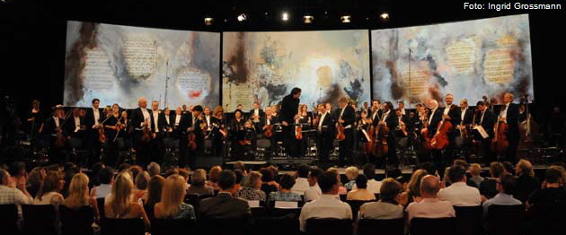 Das M�nchner Rundfunkorchester musiziert unter den Bildern von Heidi Winkler. Foto: Ingrid Grossmann